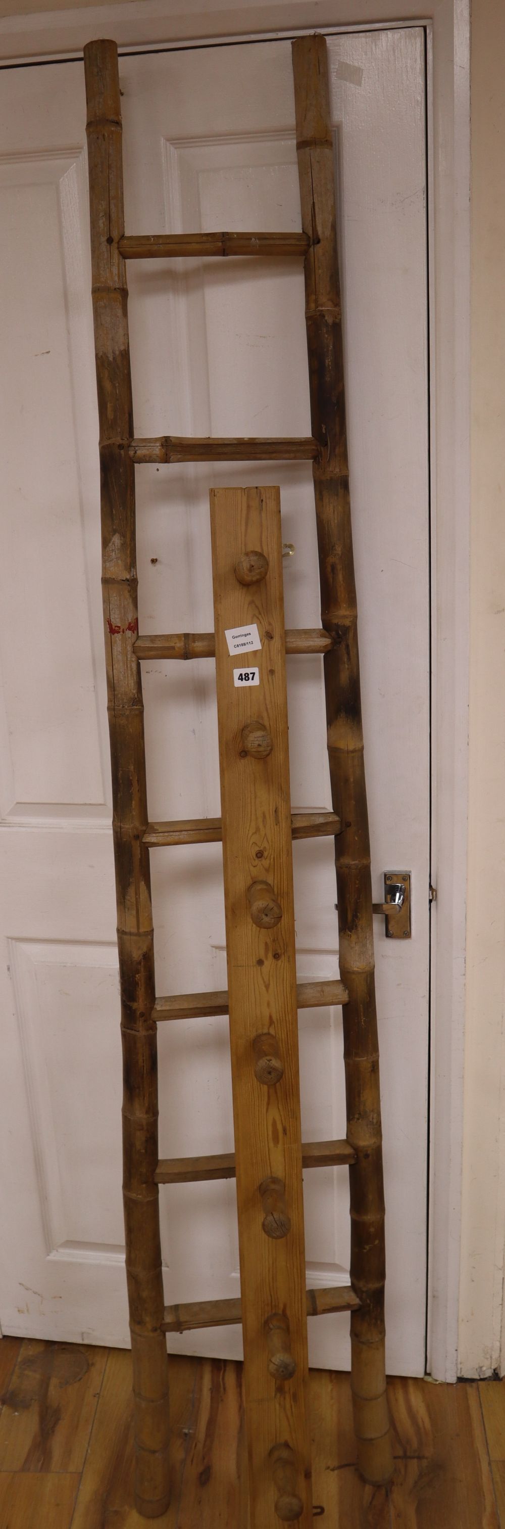 An unusual tapering bamboo seven tread step ladder, 6ft 6in., and a pine wall hanging coat rack